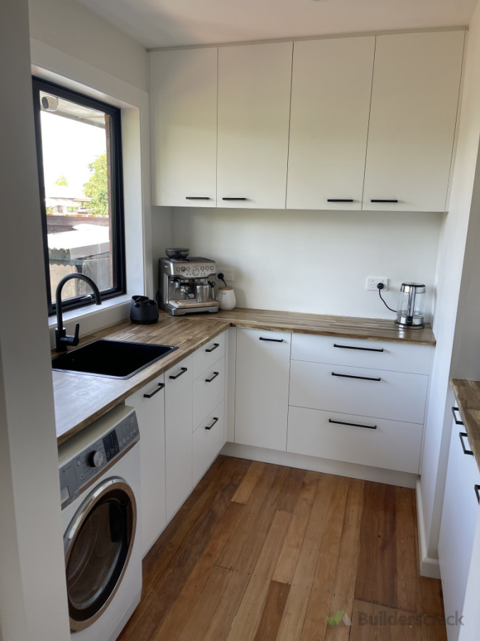 A combination of a laundry and pantry making use of space in the one room