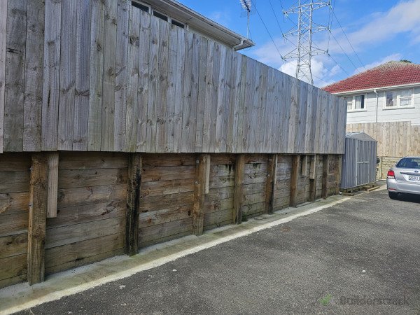 Transforming your outdoor space with a secure retaining wall and fence, blending functionality, stability, and stylish privacy seamlessly.
