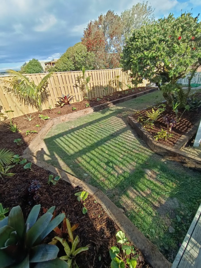 raised tropical garden using rustic railway sleepers