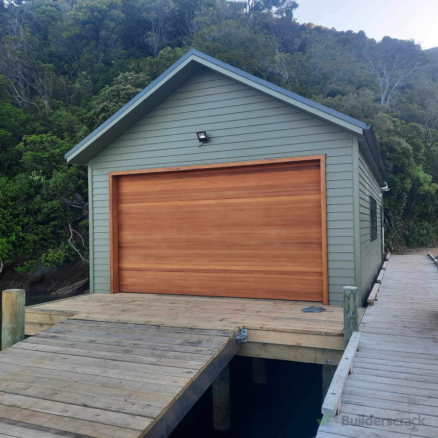 Feature Cedar door as this boatshed blends nicely into its surroundings