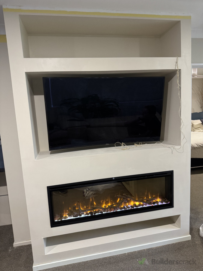 Media wall constructed with installation of fireplace, tv wall mount