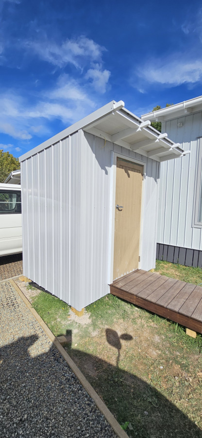 Tiny home outdoor laundry designed by owner