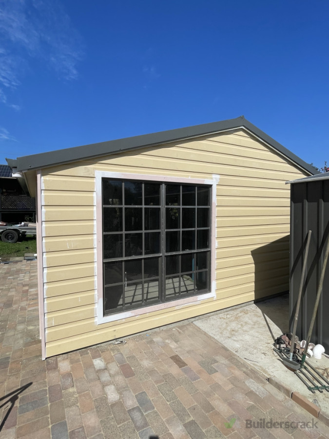 Rusticated timber weatherboards with new fascia, roof, and window installed