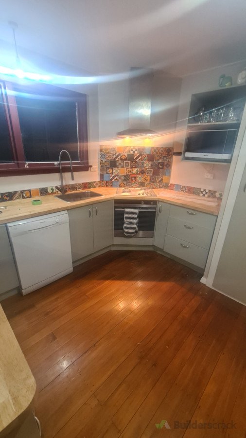 Hardwood benchtop with hand made tile splashback