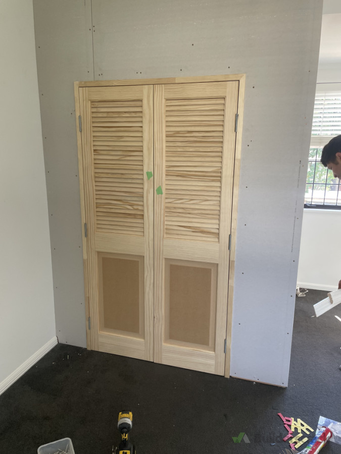 Wardrobe added to room with custom louvre doors.