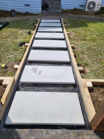 Large outdoor pavers for the path laid and packed to make level