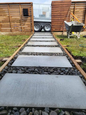 River stones for the path laid around large pavers to complete the look