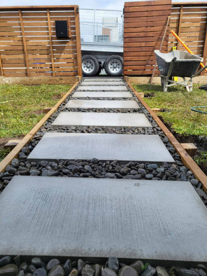 River stones for the path laid around large pavers to complete the look