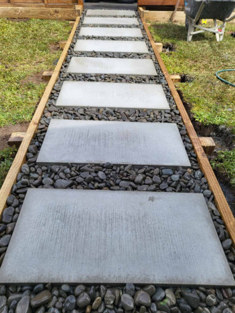 River stones for the path laid around large pavers to complete the look