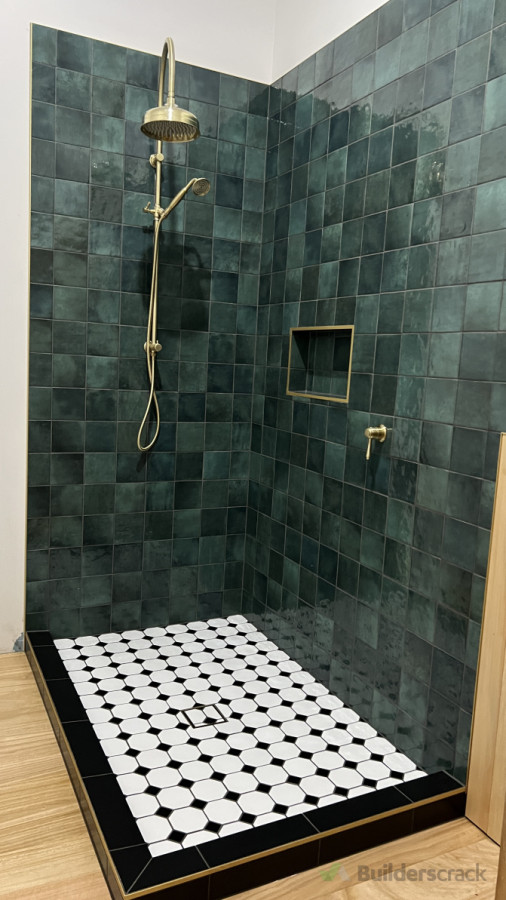 Deep green subway and mosaics tiles for shower walls and floor.