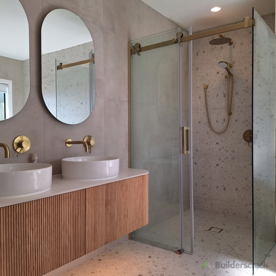 Stylish gold fixtures enhancing the modern bathroom project by Direct Tiling