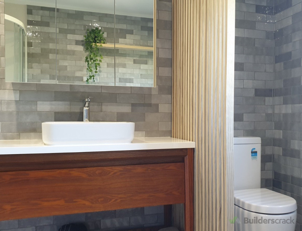 Grey subway-style porcelain tiles on bathroom walls, creating a sophisticated look by Direct Tiling