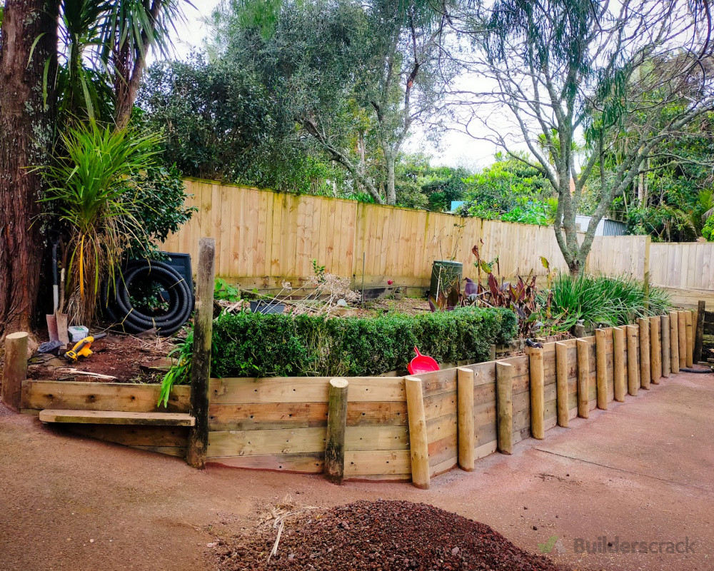Retaining wall by driveway with new drainage