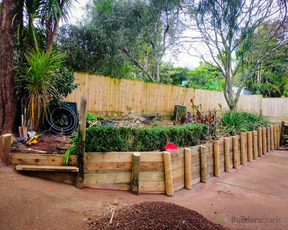 Retaining wall by driveway with new drainage