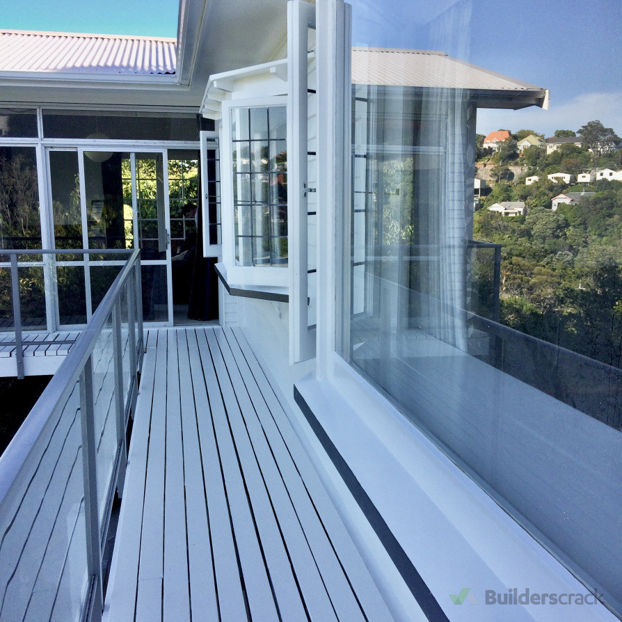 After: Fully revitalized with a crisp, clean white finish. The windows, sills, and decking are professionally painted, transforming the space with a fresh, polished look.