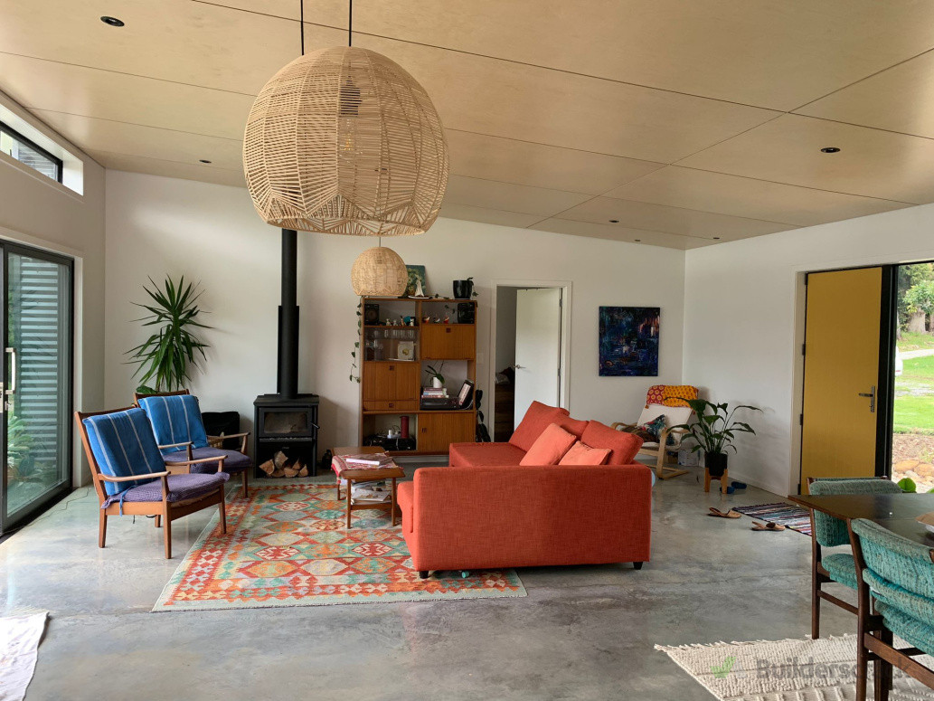 Main living room, ply raked ceiling with negative detail, burnished concrete floors all done by us.