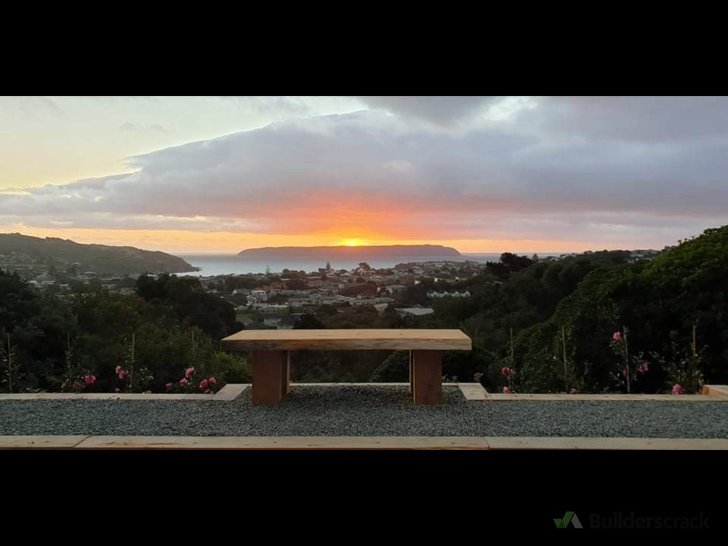 macrocarpa edging with one of our custom built Mac bench seat is a beautiful use of this back garden and perfectly centred to enjoy the view of Mana island