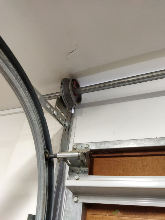 We addressed the tension issue and put everything back in place - the sectional door was back up and running that same day.