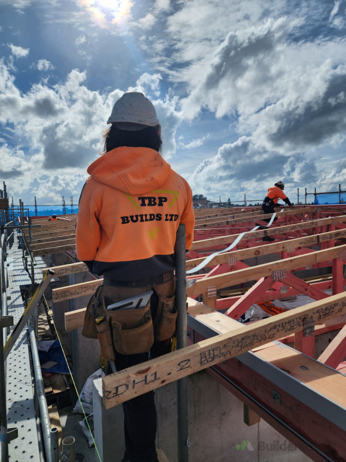 Roof Trusses with the boys finishing off the Roofing Fixings