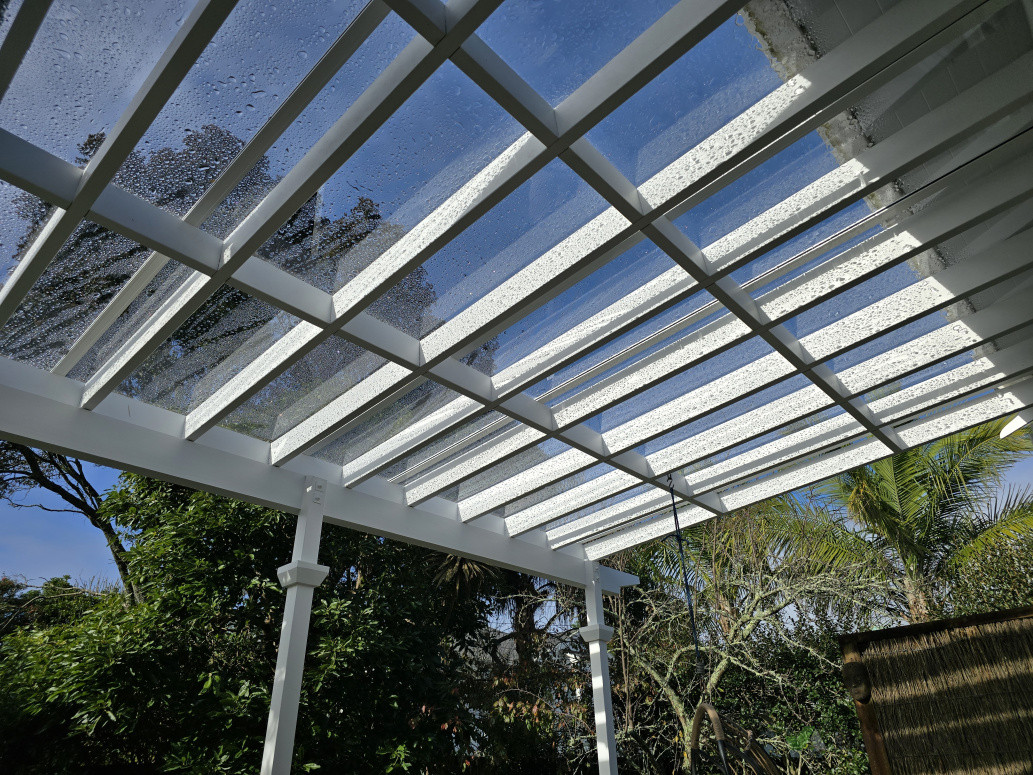 Flat polycarbonate clear roof panels on top of the pergola