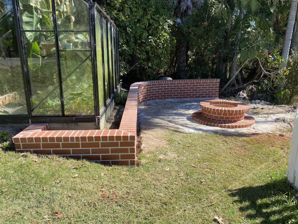 Firepit with curved wall for seating