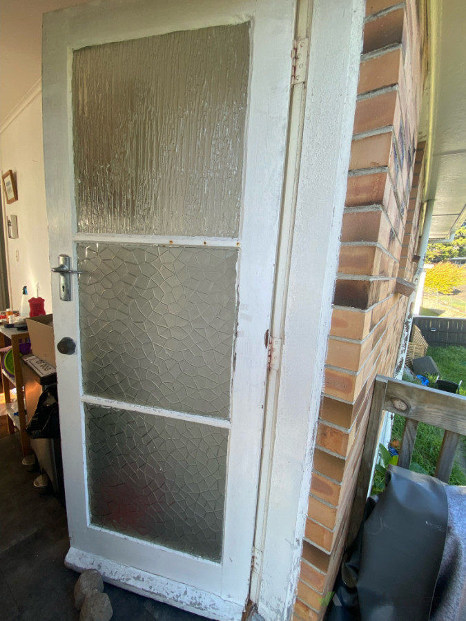 Before photo of  3 bay door before installing large rectangular dog door