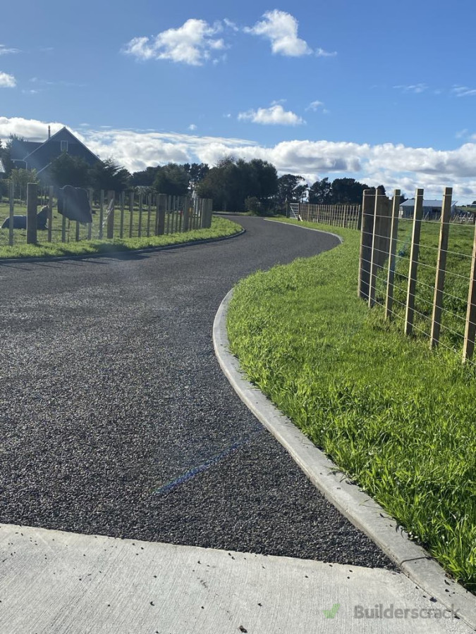 Completed chip seal driveway with concrete nibs