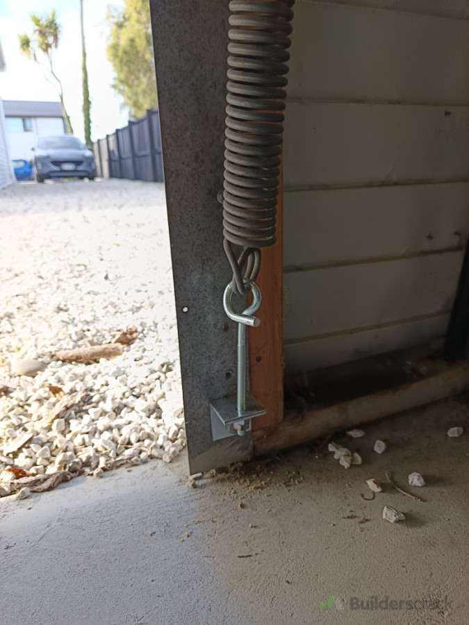 Tilt door spring anchor replacement