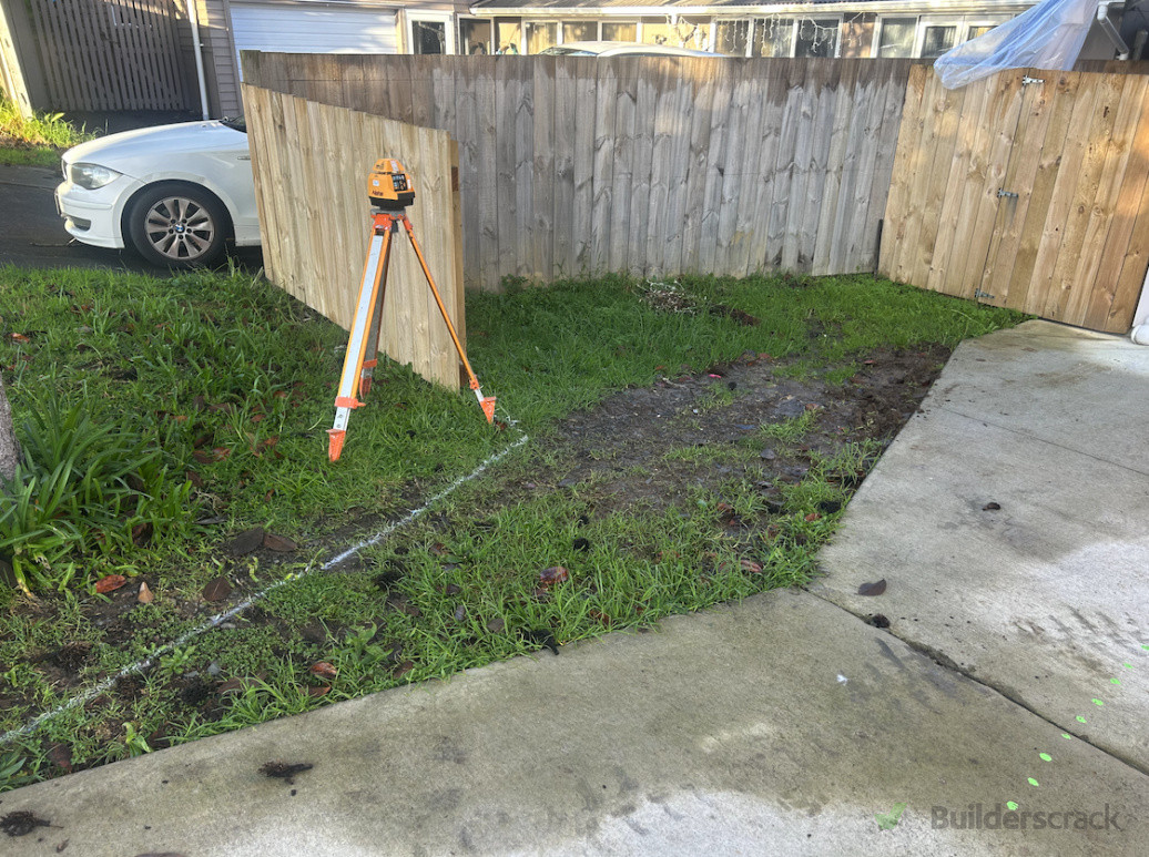 Before - One side of the driveway with existing concrete that doesn't extend far enough to the fence line or vehicle path for parking