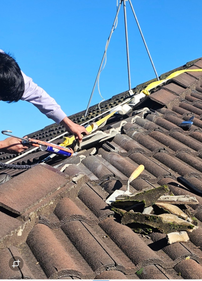Repairing roof tile.