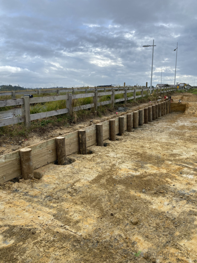 Small retaining wall constructed — believe it or not, these poles are embedded over 2.5 metres deep, as specified by the engineer, due to the nearby road creating additional load on the wall.