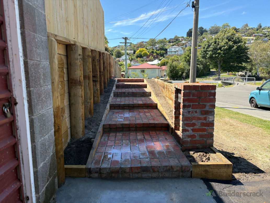 new retaining wall with brick steps