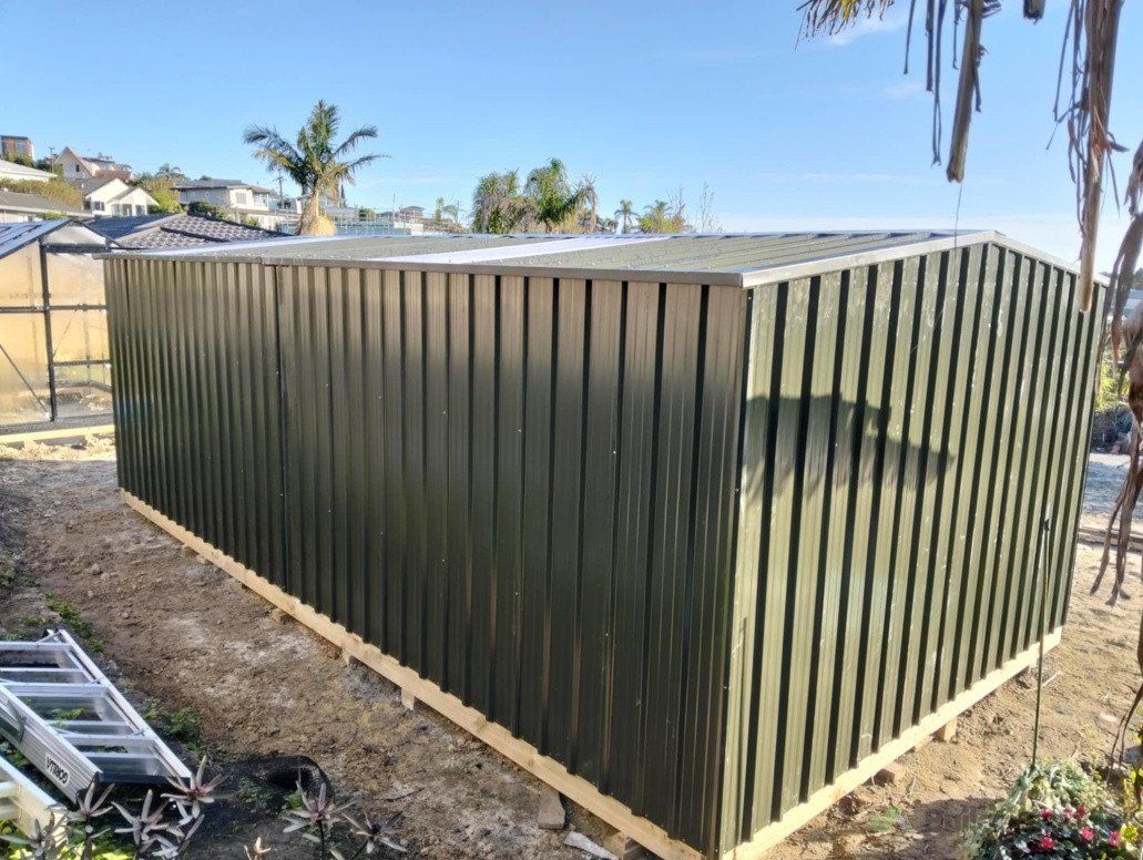Two garden sheds put up together side by side