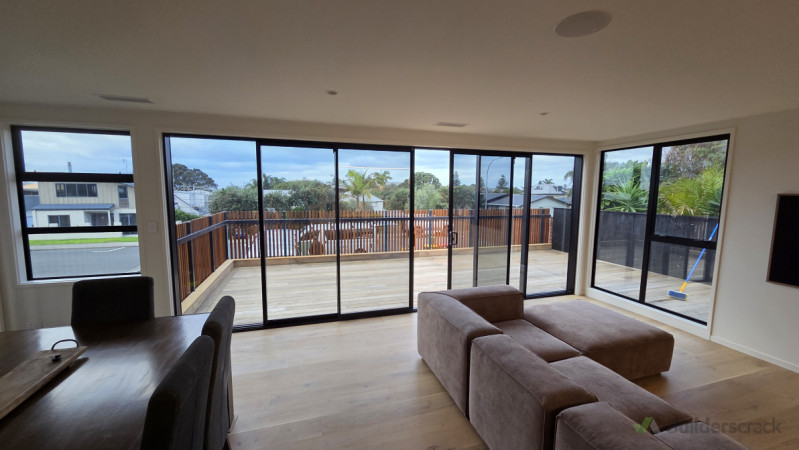 Large double stacker doors opening out onto new larger deck, deck is clad with Garapa a versatile hardwood that silvers off beautifully