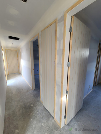 Hallway leading into multiple rooms with nice high doors.