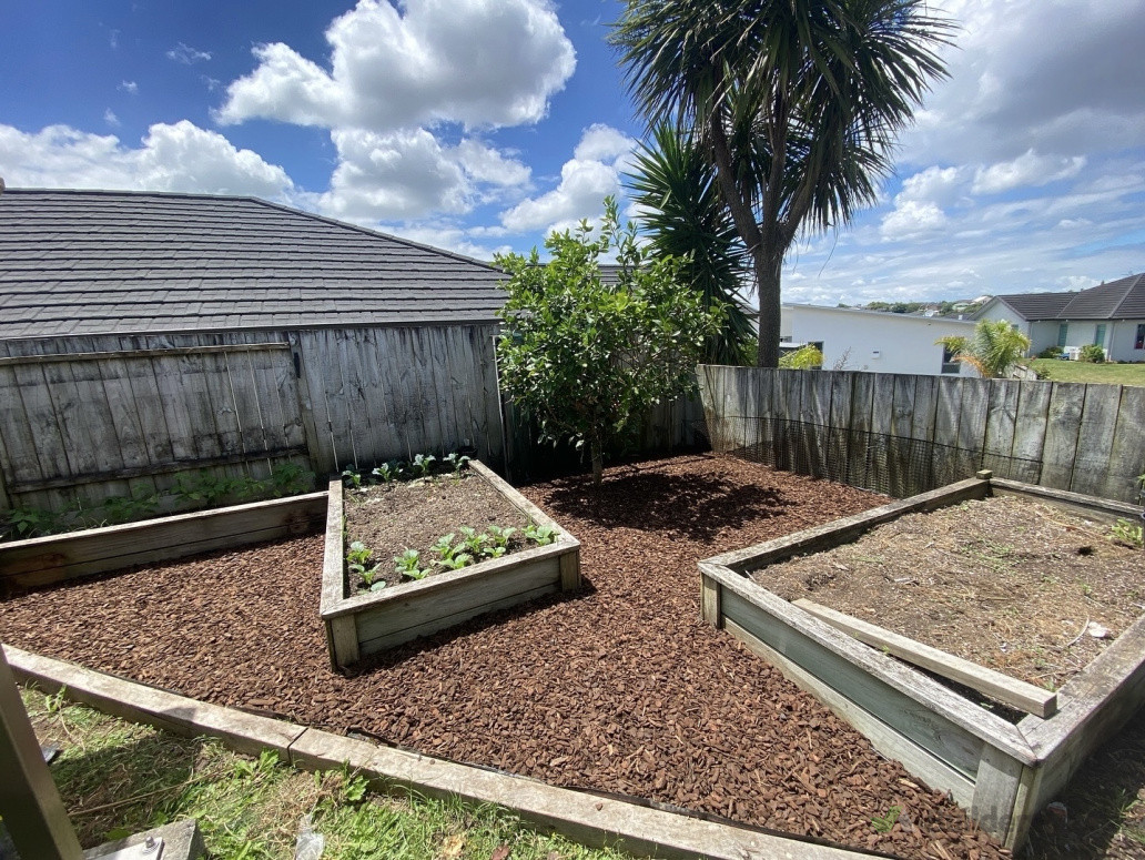 Transformed a weed-filled garden into a neat, landscaped space with weed mat and bark