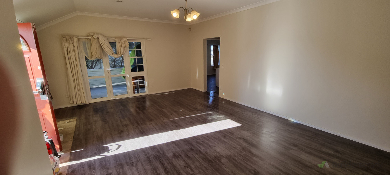 Laminate flooring installed and sealed. Walls primed and painted