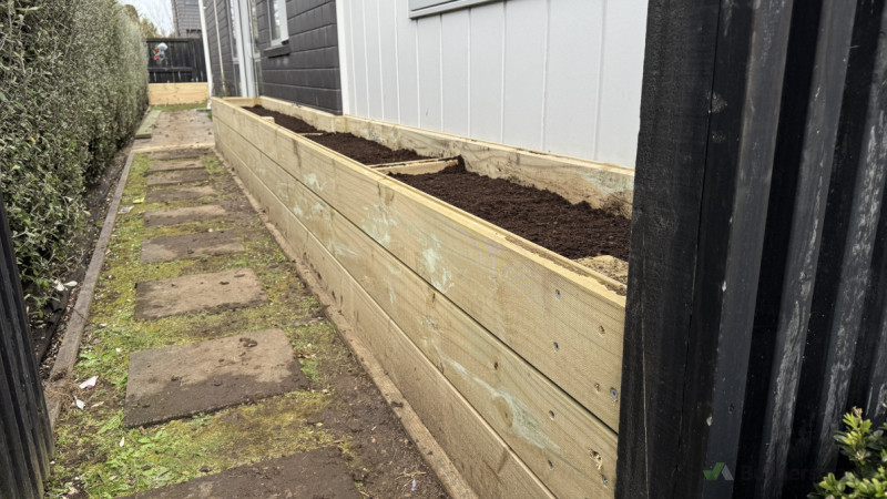 Neat, high-quality timber planter adding structure and style to the garden