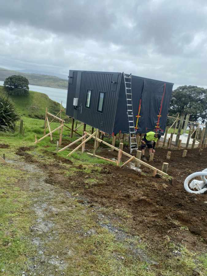 A pod house where lady had been left without someone to put on her site with pod company going bankrupt! We set out piles retained section did all the septic and water for her and know has a great view over Aotea hsrnour
