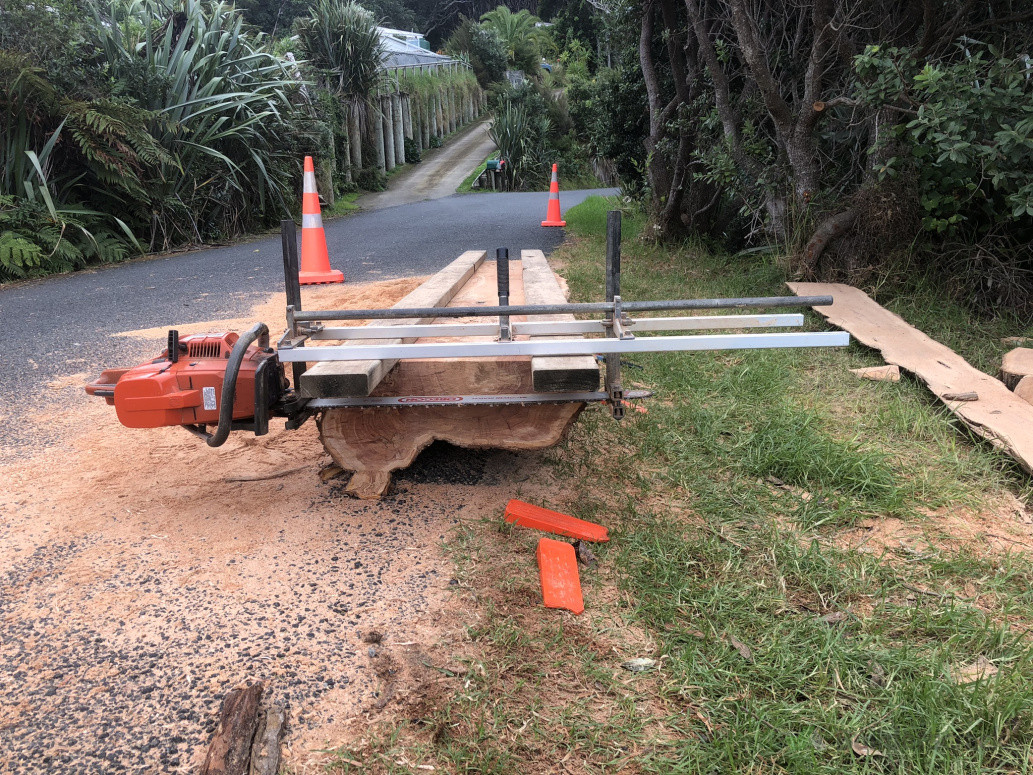 Milling slabs from a macrocarpa log. Great Barrier Island.