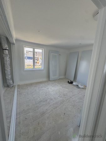 Upstairs bedroom featuring a spacious wardrobe with stacker slider doors.