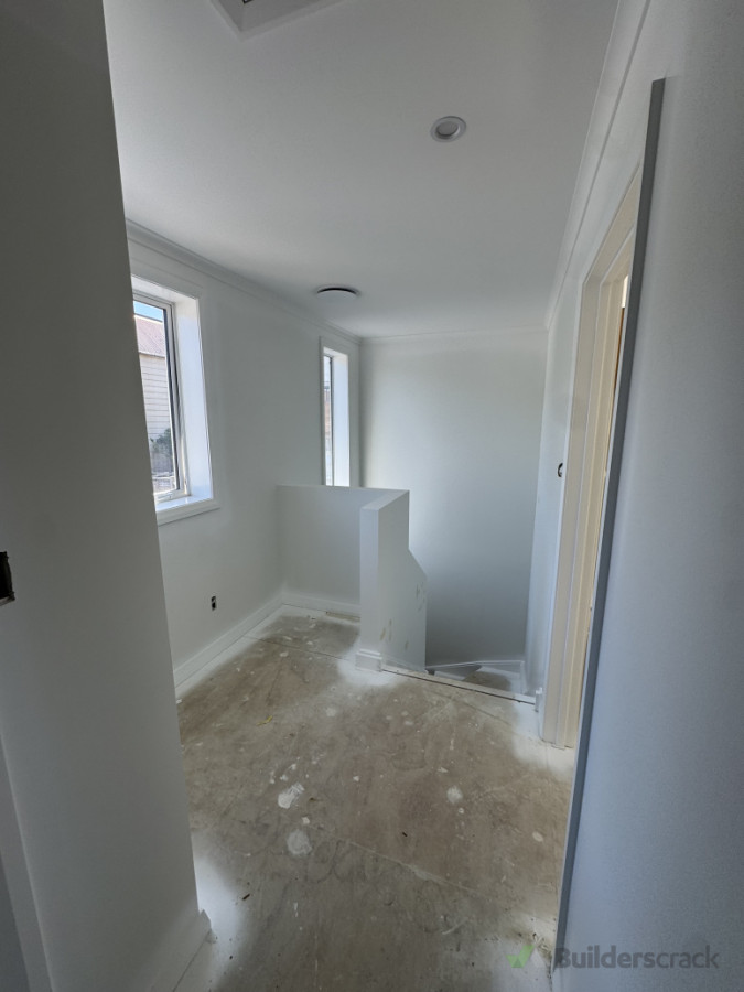 Upstairs landing freshly painted and awaiting carpet installation.