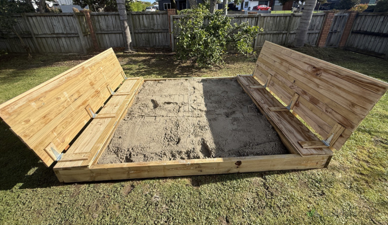 View of the sandpit, showcasing its size, clean lines, and safe design for kids.
