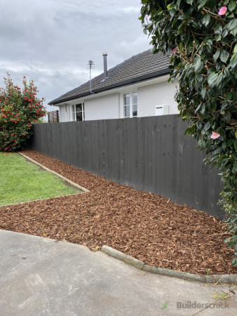 Wooden boxing was installed to create a garden edge, weed mat and bark chipped were placed afte