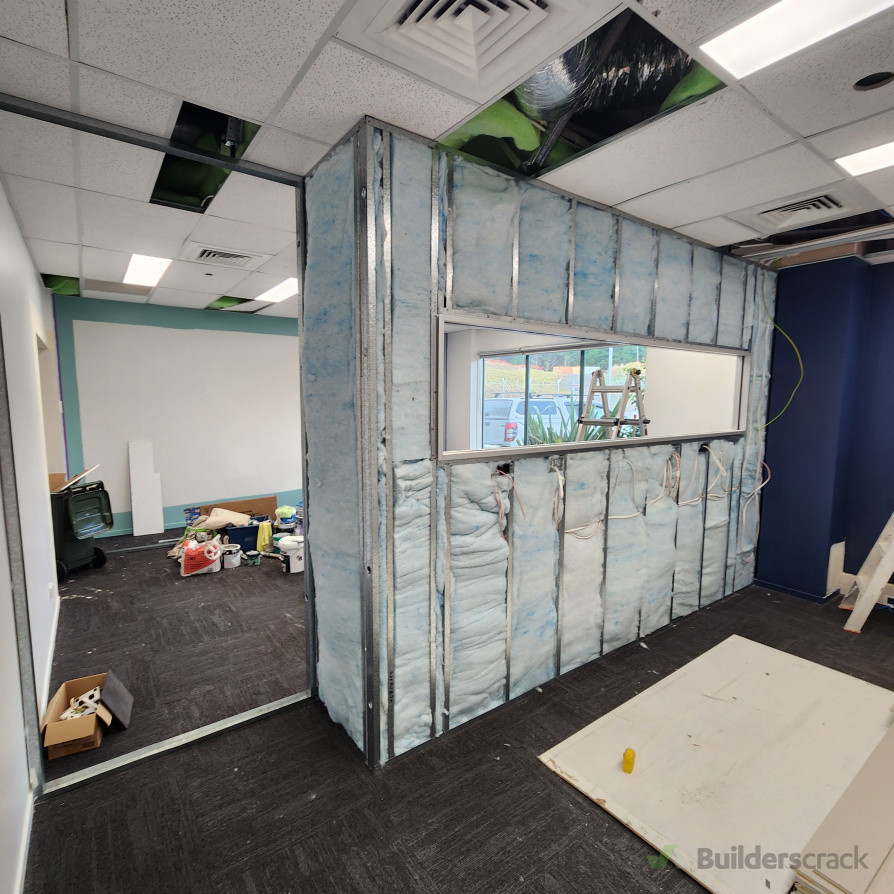 Existing large office divided into two rooms. Works included installation of 64 mm wall framing with acoustic insulation and Braiseline/Noiseline GIB lining, GIB stopping, and painting of both rooms. Custom aluminium and glass partition installed. All ele