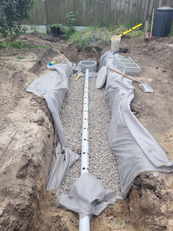 Soakage trench installed by team