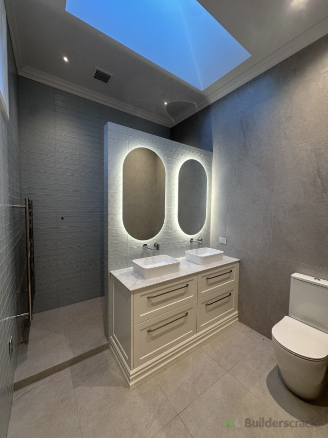 Twin mirror lights with demisters in a high end bathroom