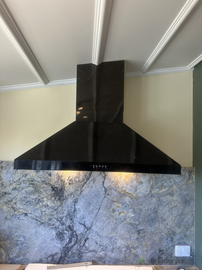 Cutting the perfect angle on the cowl of the rangehood to match the ceiling