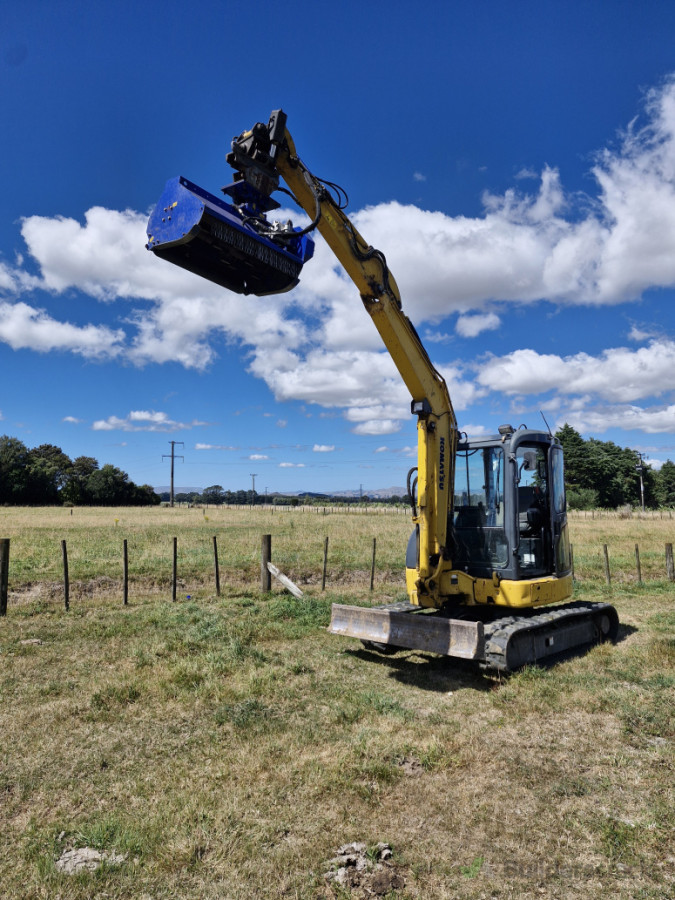 Excavator mulching for clearing  sections.