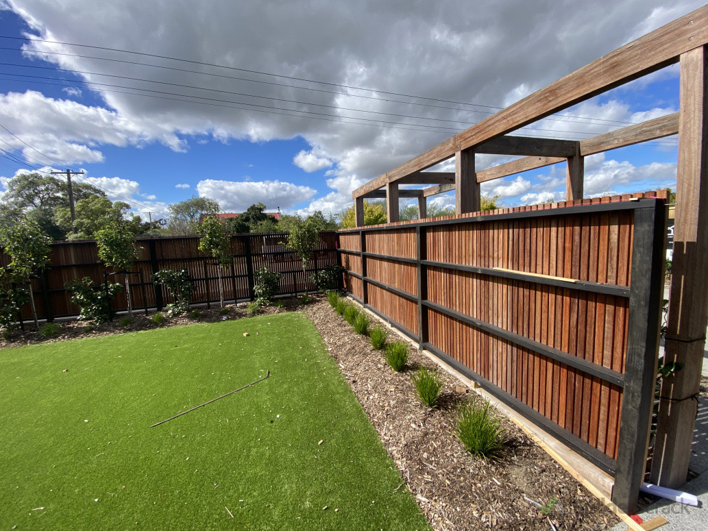 Stained black timber framing inside of our kwila batten fence